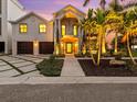 Elegant home with a grand entrance, double garage, and beautiful landscaping at 780 Eldorado Ave, Clearwater, FL 33767