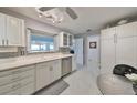 Modern white kitchen with stainless steel appliances at 100 Bluff View Dr # 404A, Belleair Bluffs, FL 33770