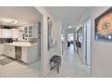 Bright entryway with view into kitchen and living spaces at 100 Bluff View Dr # 404A, Belleair Bluffs, FL 33770