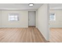 Spacious living area with light wood-look floors and an open floor plan at 8738 N Tangerine Pl, Tampa, FL 33617