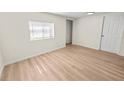 Bright bedroom featuring light wood-look flooring and neutral walls at 8738 N Tangerine Pl, Tampa, FL 33617