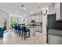 Well-lit kitchen featuring granite countertops, stainless steel appliances, and a breakfast bar at 10066 Corso Milano Dr, Tampa, FL 33625