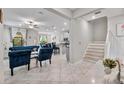Open-concept living area with tile flooring, a ceiling fan, and plenty of natural light at 10066 Corso Milano Dr, Tampa, FL 33625