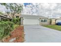House exterior showcasing a single-car garage and landscaping at 4509 Tidal Pond Rd, New Port Richey, FL 34652