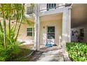 Condo building exterior, showing the entrance with tropical plants at 4315 Aegean Dr # 116C, Tampa, FL 33611