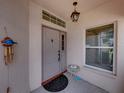 Front door entrance with sidelights and small table at 604 Masterpiece Dr # 604, Sun City Center, FL 33573