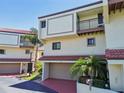 Two-story townhome with attached garage and balcony at 240 Windward Psge # 605, Clearwater Beach, FL 33767