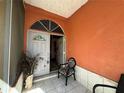 Inviting front porch with tiled flooring and seating at 33255 State Road 70 E, Myakka City, FL 34251