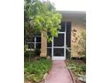Front entry with screen door and walkway at 33255 State Road 70 E, Myakka City, FL 34251