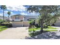 Two-story house with a two-car garage and nicely landscaped yard at 19334 Autumn Woods Ave, Tampa, FL 33647