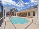 Relaxing screened-in pool area with patio furniture, ideal for outdoor entertaining at 19334 Autumn Woods Ave, Tampa, FL 33647