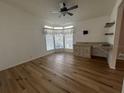 Bright office space with wood-look flooring and built-in shelving at 6048 Ridgeway Dr, Zephyrhills, FL 33542