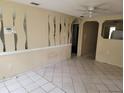 Spacious living area with tile floors, decorative wall cutouts, and an open feel, ready for personalization at 8312 N Mulberry St, Tampa, FL 33604