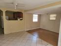Inviting living space with tile and wood-look floors, open to the kitchen, and filled with potential at 8312 N Mulberry St, Tampa, FL 33604