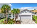 Single-Gathering house with a two-car garage and manicured lawn at 15503 Corona Del Mar Dr, Wimauma, FL 33598