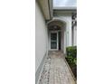 Inviting entryway with a brick walkway and arched entry at 10406 Mulligan Ct, Tampa, FL 33647