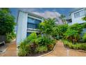 Exterior of a condo building with landscaping and a walkway at 1555 Tarpon Center Dr # 136, Venice, FL 34285