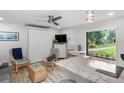 Living room with Murphy bed, sliding glass door and access to patio at 1555 Tarpon Center Dr # 136, Venice, FL 34285