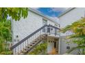 Exterior view of a two story building with stairs leading to the entrance at 1555 Tarpon Center Dr # 136, Venice, FL 34285