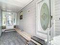 Front entry with a glass door and a small covered porch at 34051 Brown Byu, Wesley Chapel, FL 33543