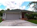 Front view of a house with red door at 20006 Nob Oak Ave, Tampa, FL 33647