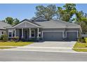 Attractive gray house with a well-paved driveway and a two-car garage at 157 Hidden Estates Ct, Brandon, FL 33511