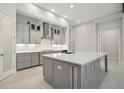Modern kitchen featuring grey cabinetry, white countertops, stainless steel appliances, and recessed lighting at 157 Hidden Estates Ct, Brandon, FL 33511