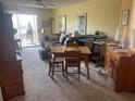 Living room with sofa, dining table, and hardwood floors at 115 112Th Ne Ave # 605, St Petersburg, FL 33716
