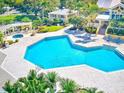 Community pool with surrounding patio and landscaping at 115 112Th Ne Ave # 605, St Petersburg, FL 33716