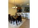 Dining area with table and chairs, adjacent to kitchen at 3464 Silverstone Ct, Plant City, FL 33566