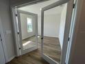 Bright office with glass French doors and wood-look flooring at 18207 Fattoria Ter, Lakewood Ranch, FL 34211