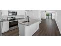 Open concept kitchen with island, stainless steel appliances, and granite counters at 29508 Fedora Cir, Brooksville, FL 34602