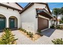 Townhome with Mediterranean style and a two-car garage at 17231 Holly Well Ave, Wimauma, FL 33598