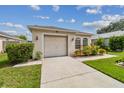 Front view of a single-story house with a garage and neatly landscaped front yard at 6108 Lanshire Dr, Tampa, FL 33634