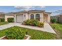 House exterior featuring a one-story home with a garage and well-manicured landscaping at 6108 Lanshire Dr, Tampa, FL 33634