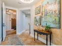 Elegant condo entryway with artwork and console table at 140 Riviera Dunes Way # 303, Palmetto, FL 34221