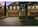 Two-story townhome with attached garage at dusk at 17032 Vilesta Dr, Lutz, FL 33548