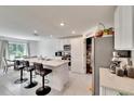 Modern kitchen with white cabinets, island, and stainless steel appliances at 3729 Capri Coast Dr, Plant City, FL 33565