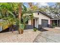 Newly renovated home with a gray garage door and attractive landscaping at 2408 50Th S St, Gulfport, FL 33707