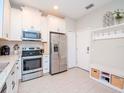 Bright kitchen featuring stainless steel appliances and white cabinets at 9107 Carolina Wren Dr, Tampa, FL 33626