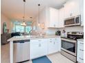 Open concept kitchen with stainless steel appliances and granite countertops at 9107 Carolina Wren Dr, Tampa, FL 33626