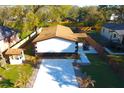 A high-angle shot reveals a well-kept home, a fenced-in yard and a newly-paved driveway at 3010 E 149Th Ave, Lutz, FL 33559