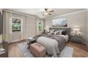 Comfortable main bedroom featuring natural light, neutral tones, and stylish decor at 331 Star Shell Dr, Apollo Beach, FL 33572