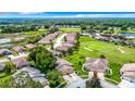 Aerial view of a beautiful community with houses, golf course and conservation at 13400 Norman Cir, Hudson, FL 34669