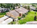 Aerial view of a single-Gathering home with a two-car garage and a large backyard at 13400 Norman Cir, Hudson, FL 34669