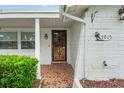 Front entrance with a metal security door and tiled porch at 7015 Flaggler Dr, Port Richey, FL 34668