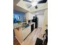 Modern kitchen with white cabinets, granite countertops, and black appliances at 10200 Gandy Blvd # 1116, St Petersburg, FL 33702