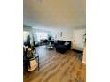 Bright living room with L-shaped sofa and wood-look floors at 10200 Gandy Blvd # 1116, St Petersburg, FL 33702