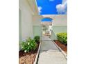White metal gate leading to a paved walkway at 761 Tremont Greens Ln # 61, Sun City Center, FL 33573