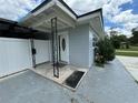 Front entry with a covered porch and decorative railing at 2702 Campus Hill Dr, Tampa, FL 33612